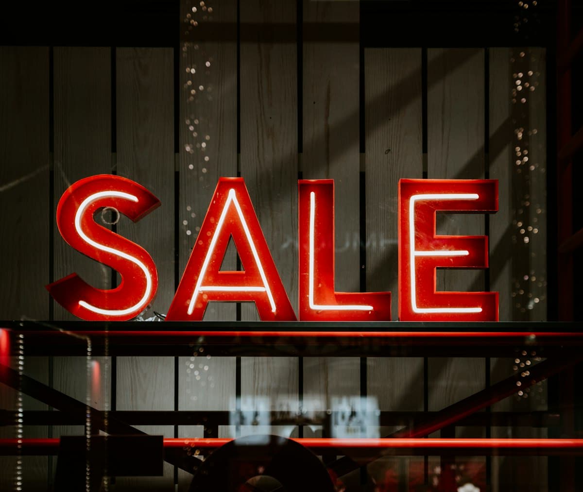 Red and white sale LED sign advertising discounts in a shop