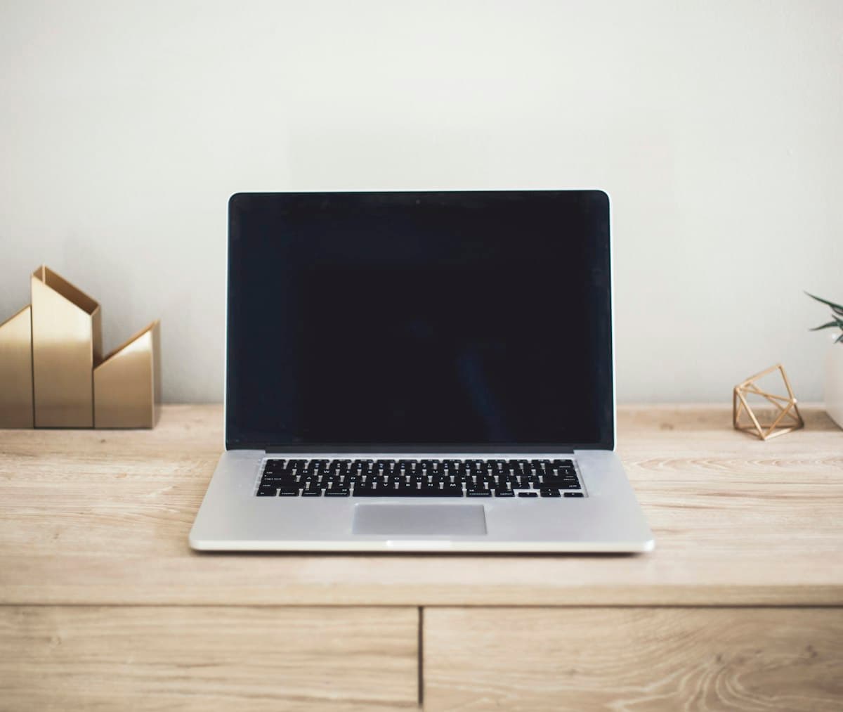 Laptop on a brown table, a typical setup for a freelancer working from home