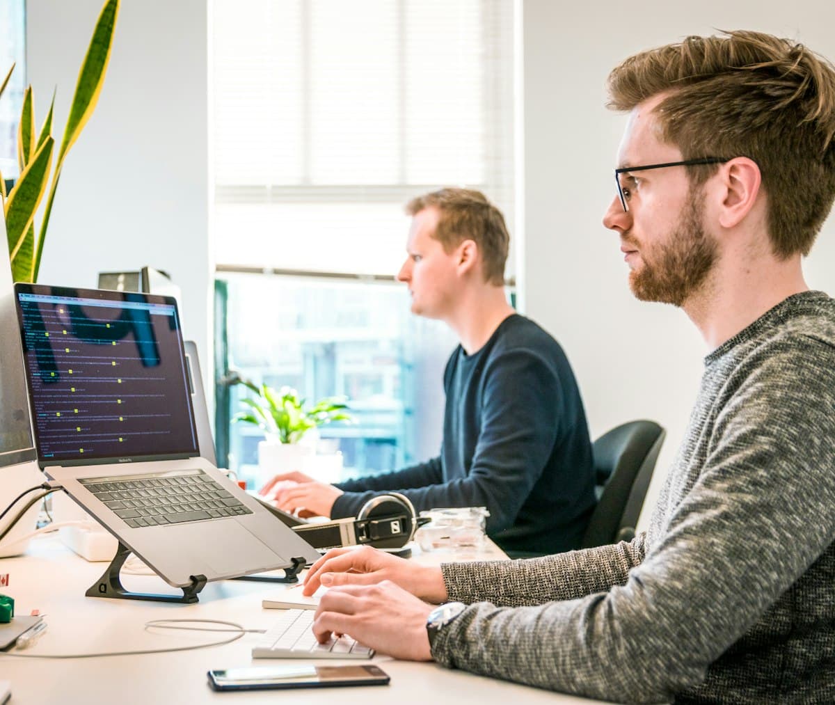 Man sitting on a chair using a keyboard at work