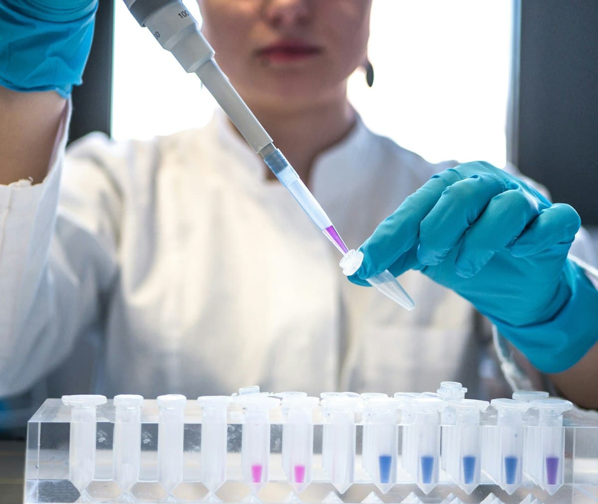 Scientist using a pipette with test tubes in a laboratory