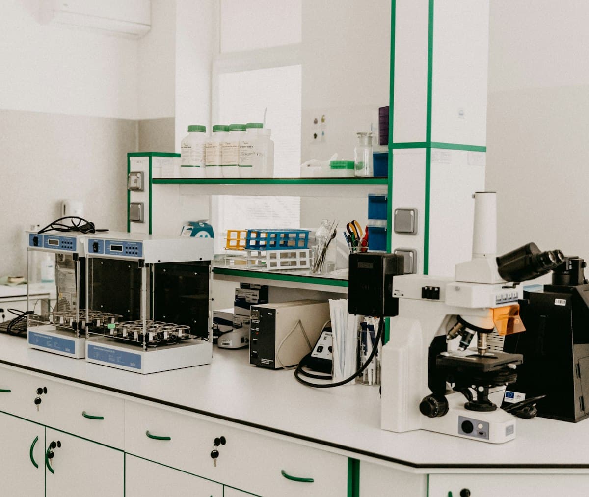 Laboratory workbench with a microscope and analytical equipment in a bright room