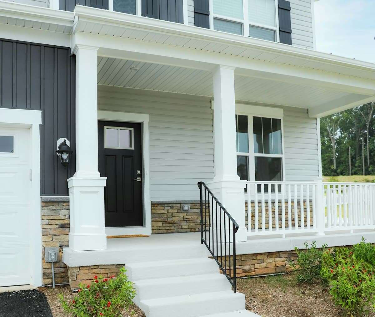 White family house with a black front door, the kind of home a mortgage buys
