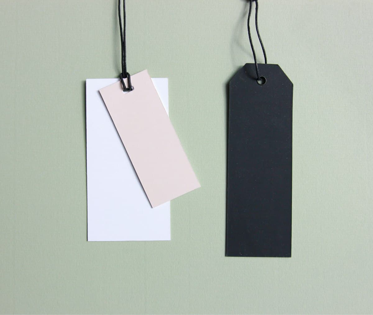 Three assorted-color paper price tags used to set selling prices and margins