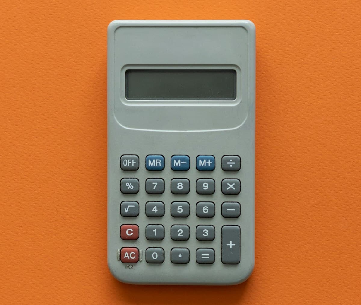 Calculator on a table for working out the original price before a percentage