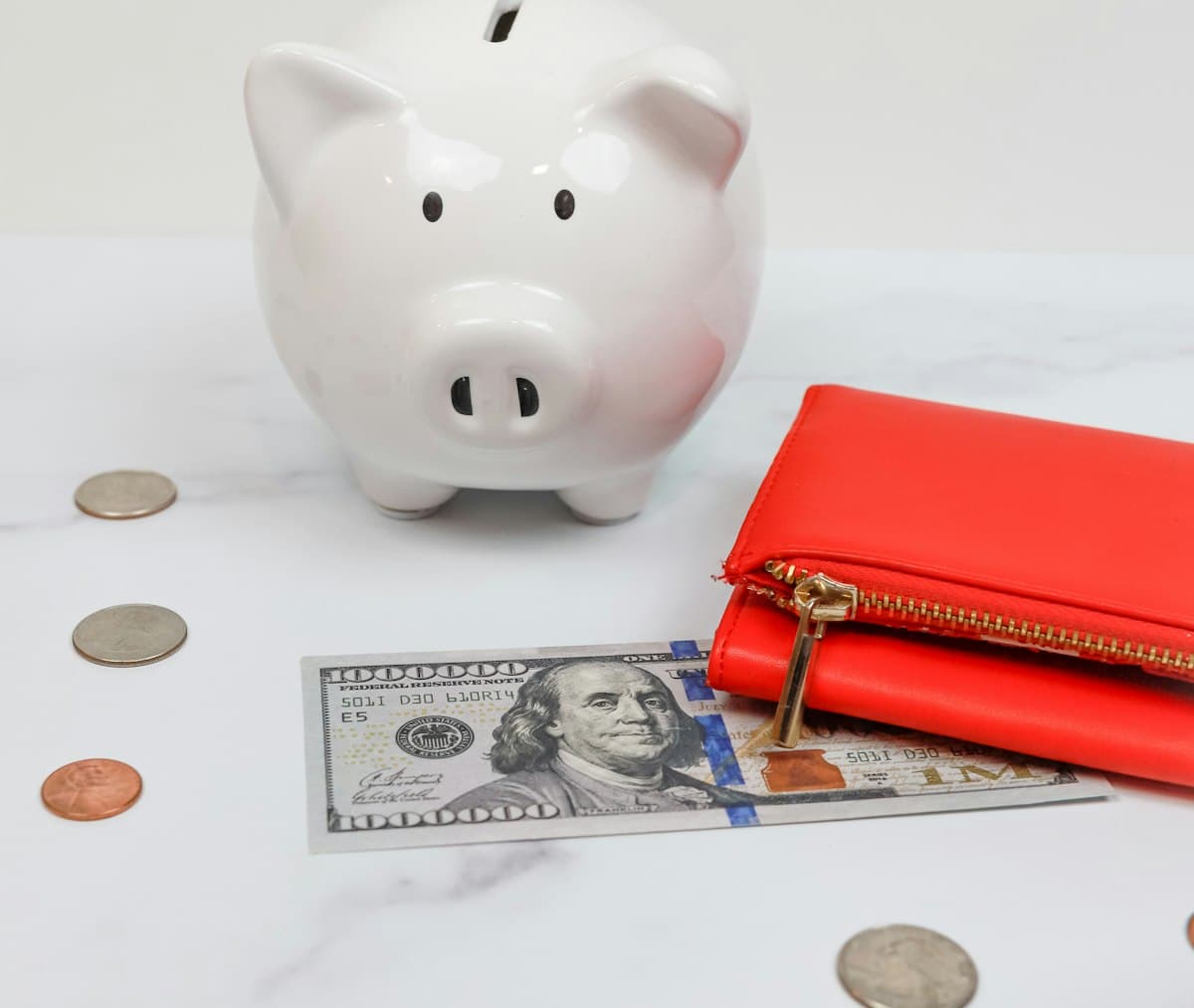 Piggy bank with coins beside it, showing money set aside toward a savings goal