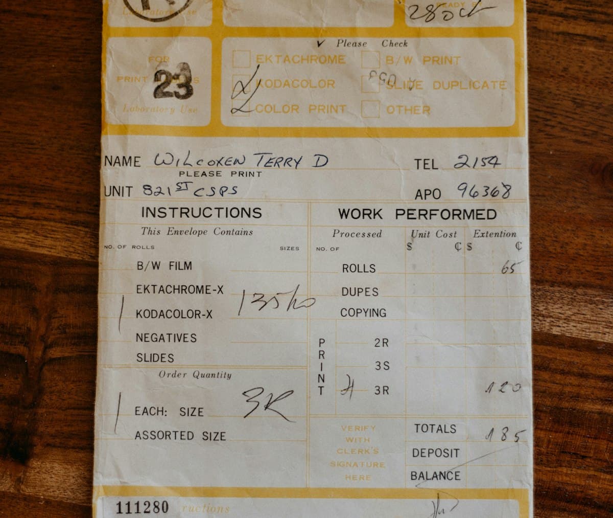Paper receipt lying on a wooden table, like a payslip listing pay and deductions