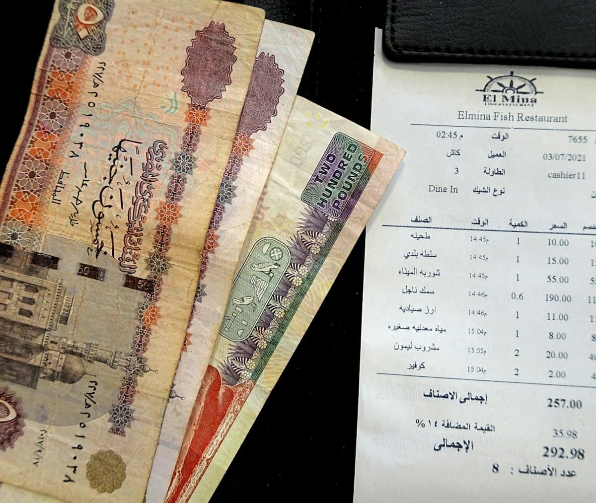 Pile of cash on a table, ready to split the bill and leave a tip