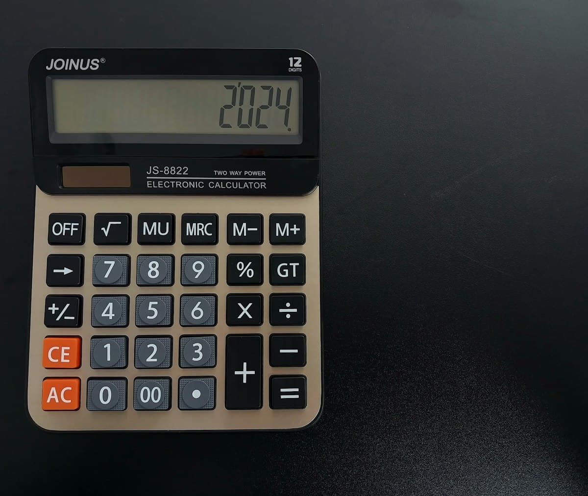 Calculator sitting on a table, used to add or remove VAT from a price